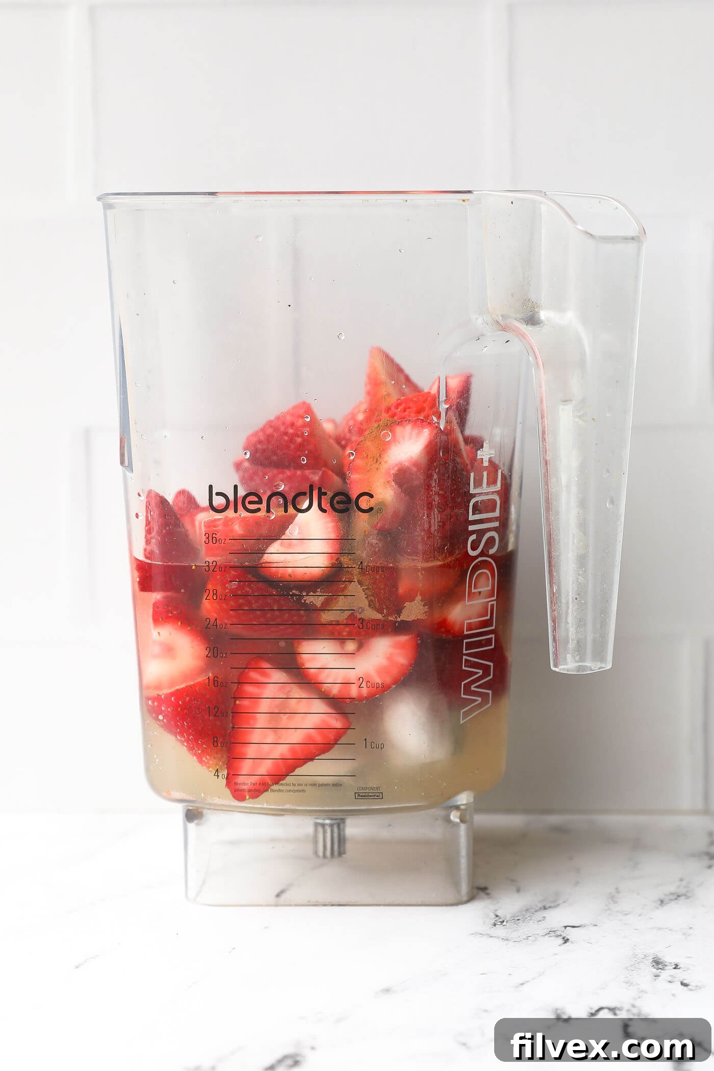 Ingredients being poured into a high-speed blender, ready to be mixed into a smooth daiquiri mocktail.