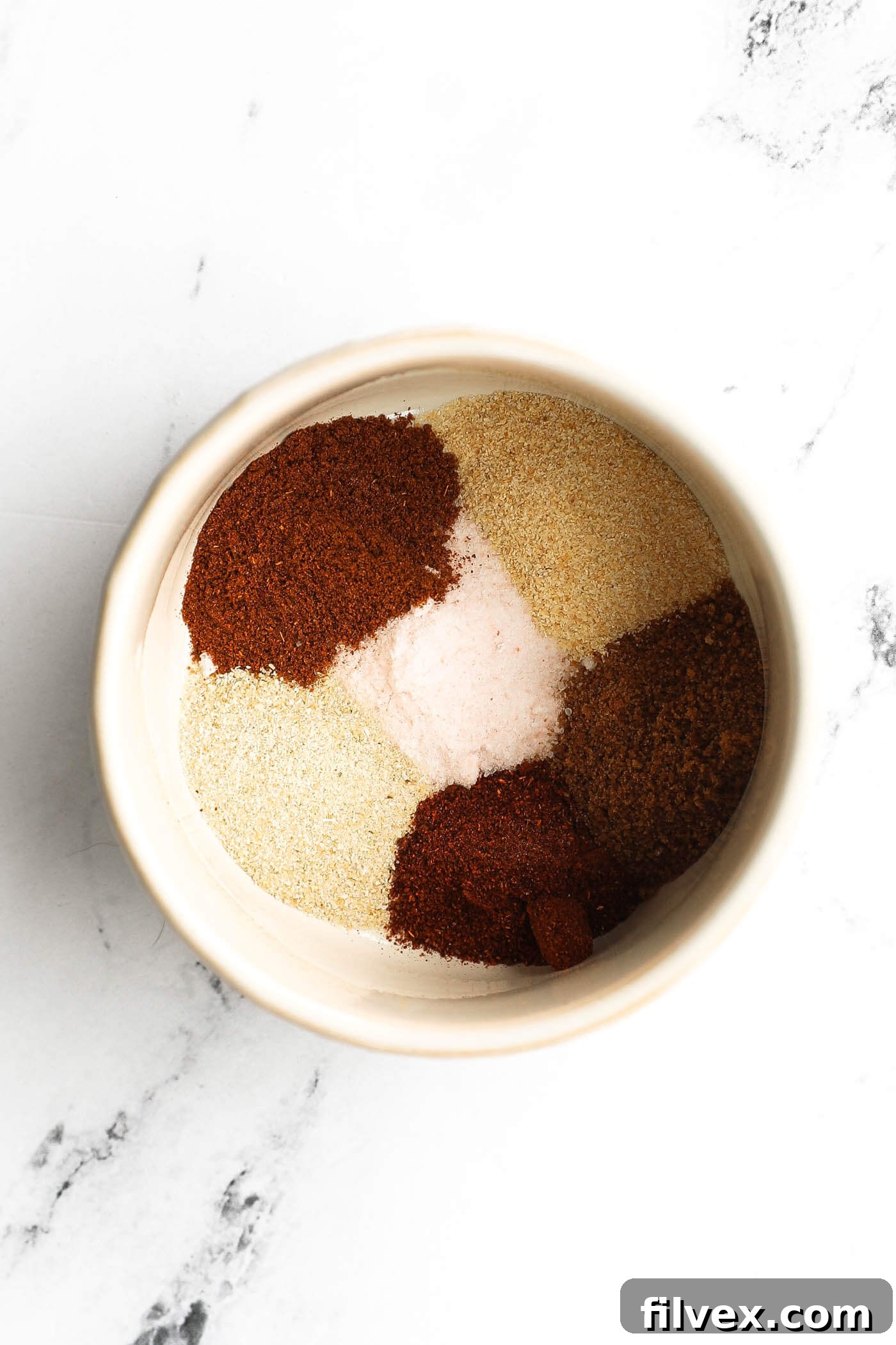 Chicken seasoning ingredients mixed in a bowl.