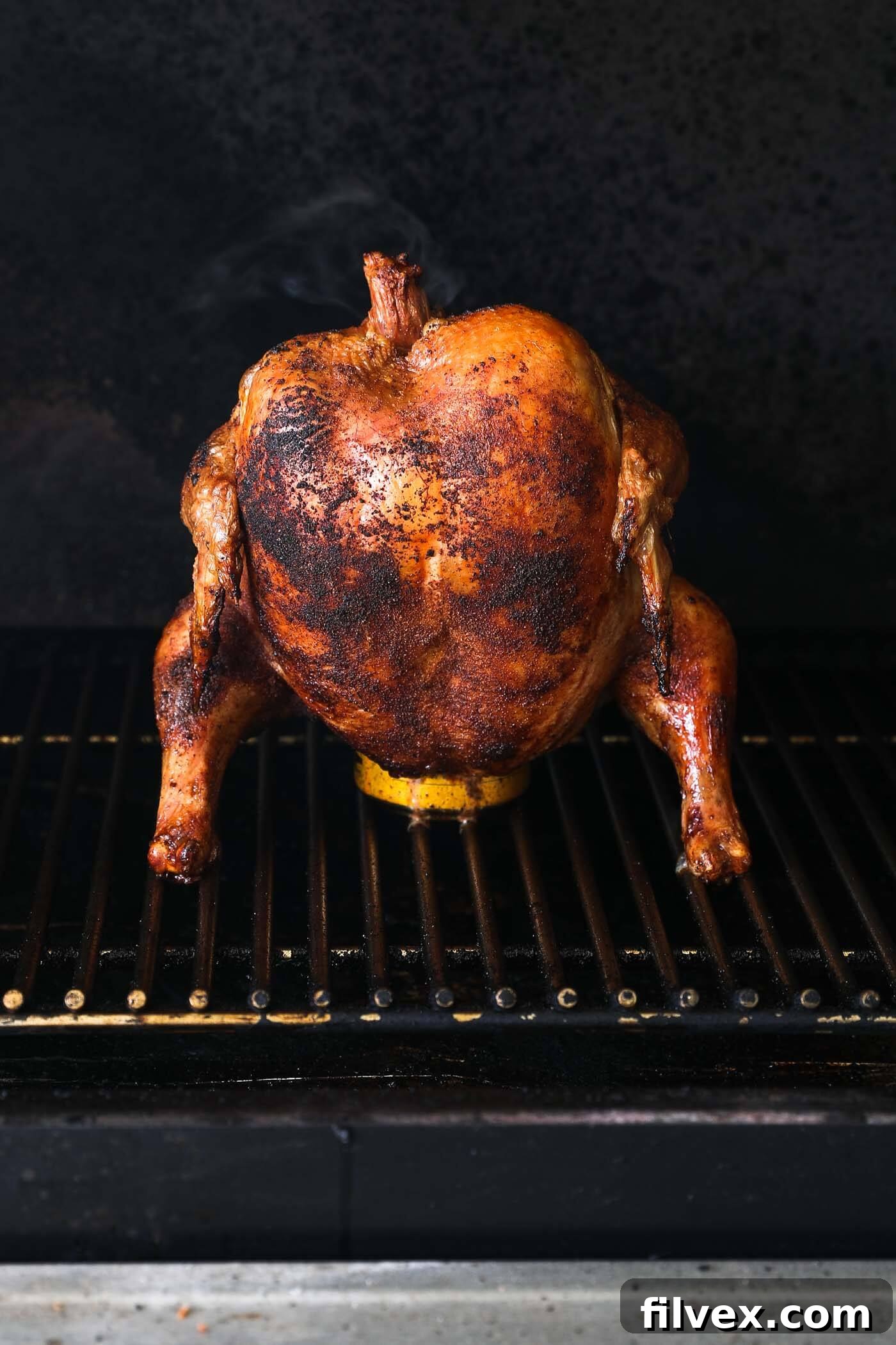 Beer can chicken roasting on a Traeger grill at 400 degrees Fahrenheit.