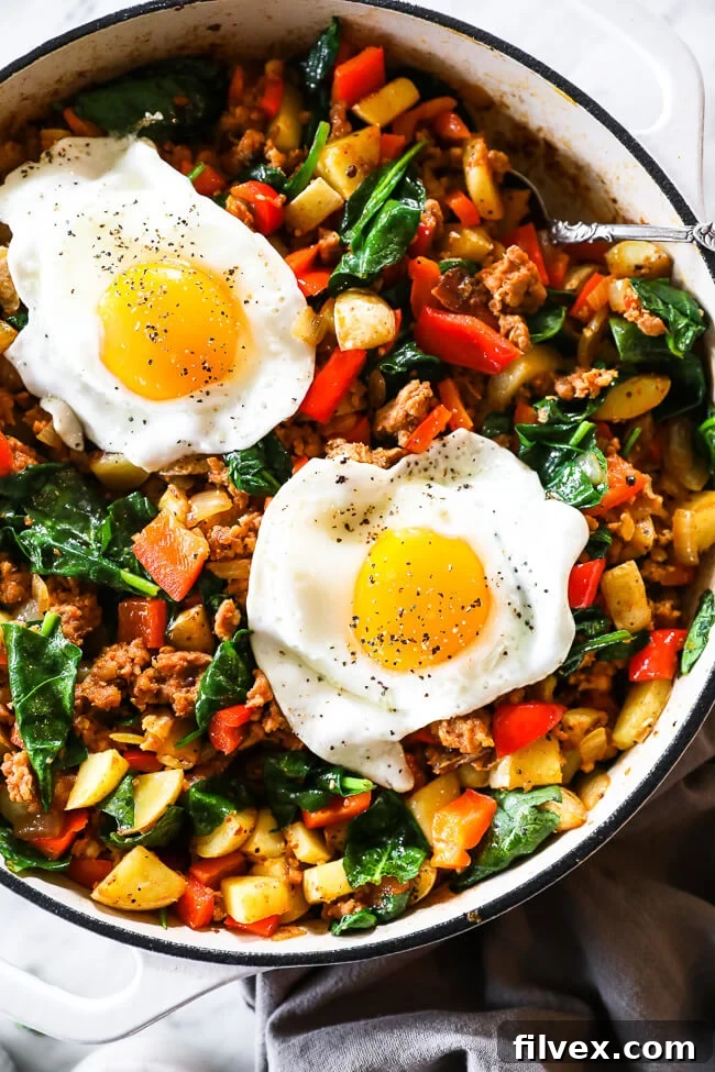 Easy chorizo hash in skillet with two eggs on top, ready to be served for a hearty breakfast.