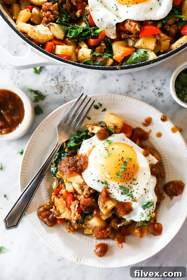 Easy chorizo hash on a plate with eggs and salsa on top, a vibrant and delicious breakfast.