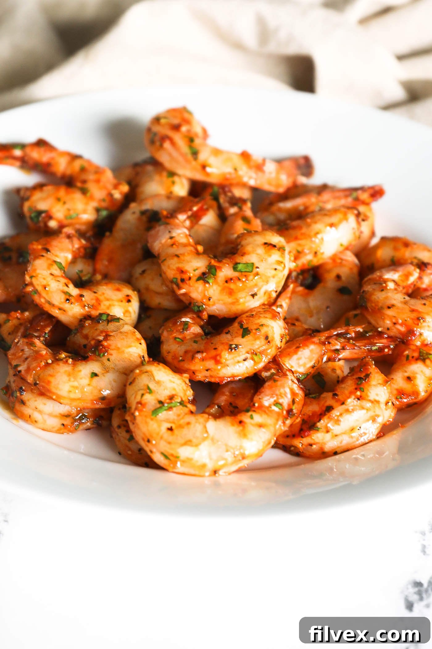 A vibrant and appetizing plate of perfectly smoked shrimp, garnished and ready to be served, highlighting its delicious texture and visual appeal as an appetizer or a fulfilling main course.