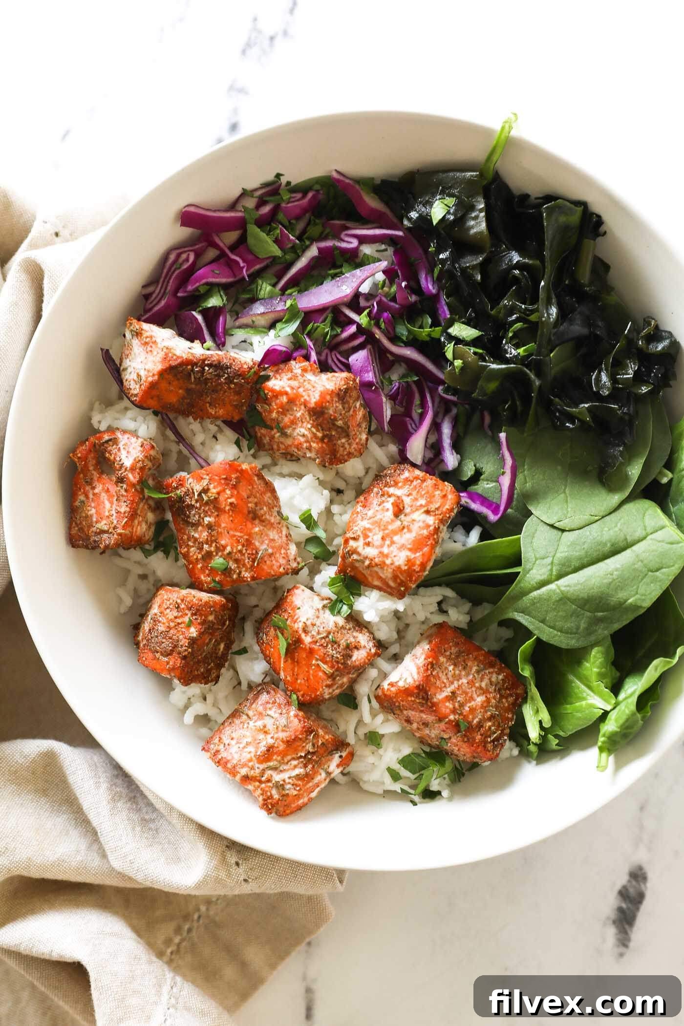 Perfectly seasoned salmon bites ready to be cooked on a baking sheet