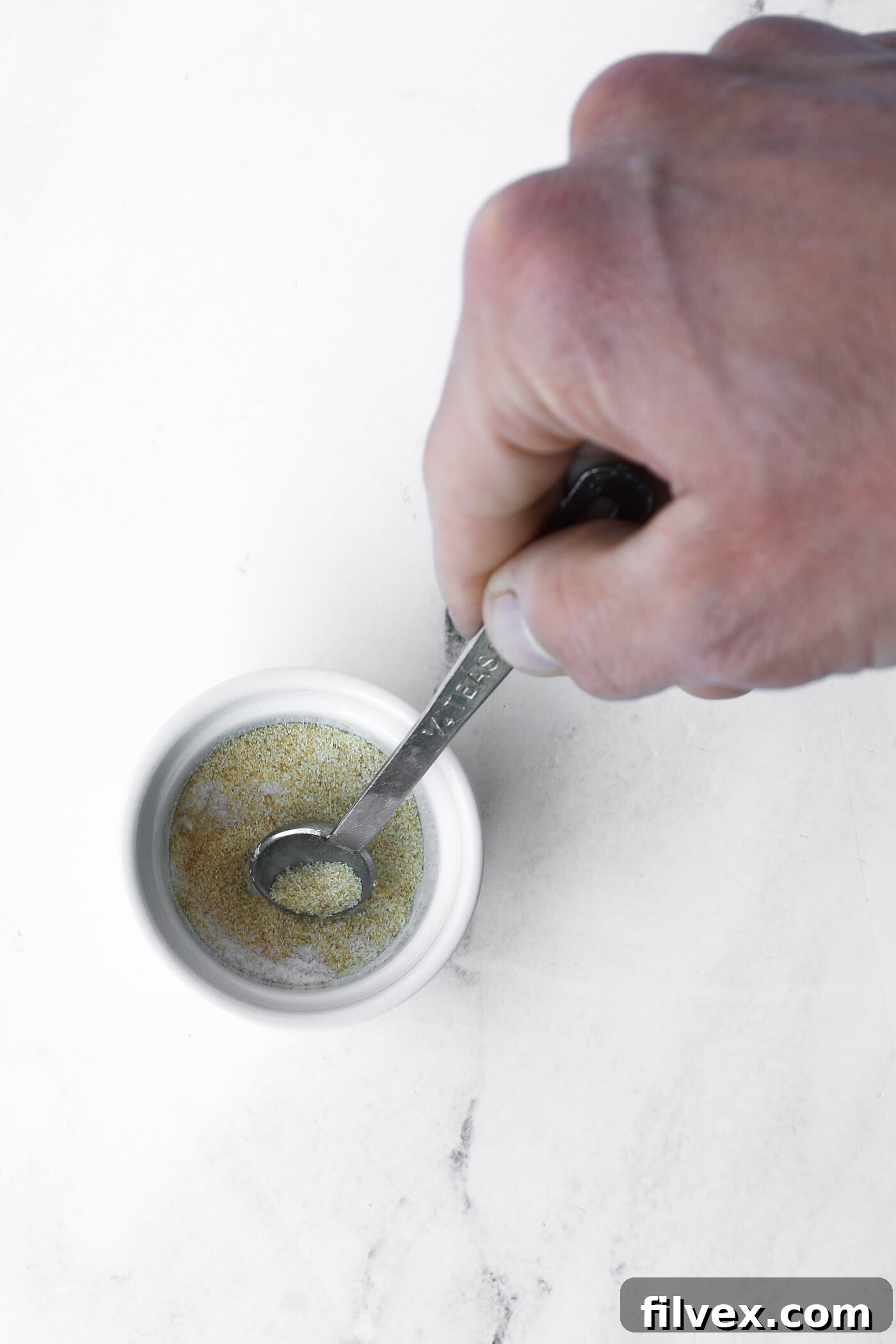 Preheating the air fryer and mixing the seasoning blend for Brussels sprouts.