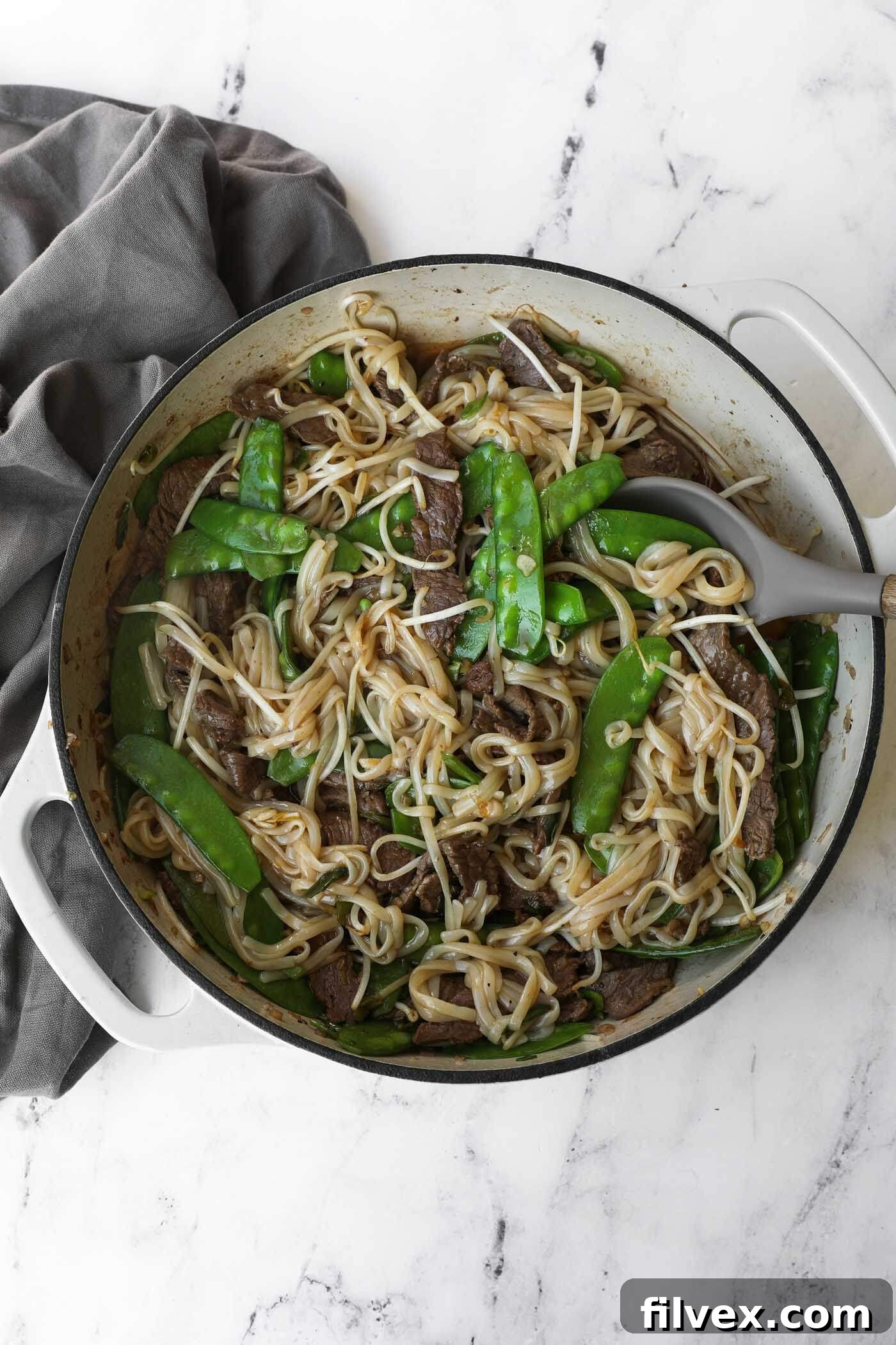 A freshly cooked plate of Beef Pad Thai, perfectly sauced and ready to enjoy, highlighting the delicious texture of the noodles and beef.