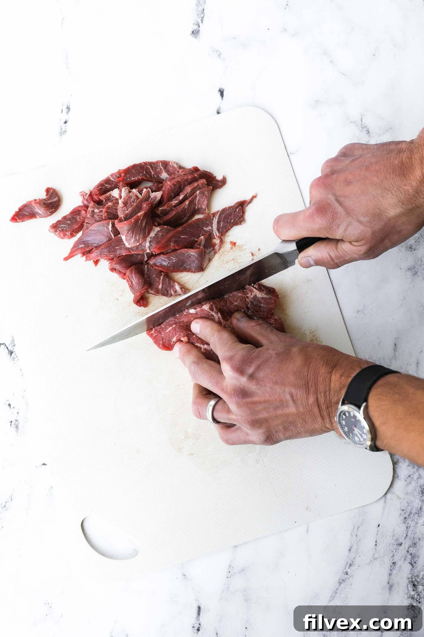 Thinly sliced sirloin steak strips, expertly cut for quick cooking and tender texture in the Pad Thai.