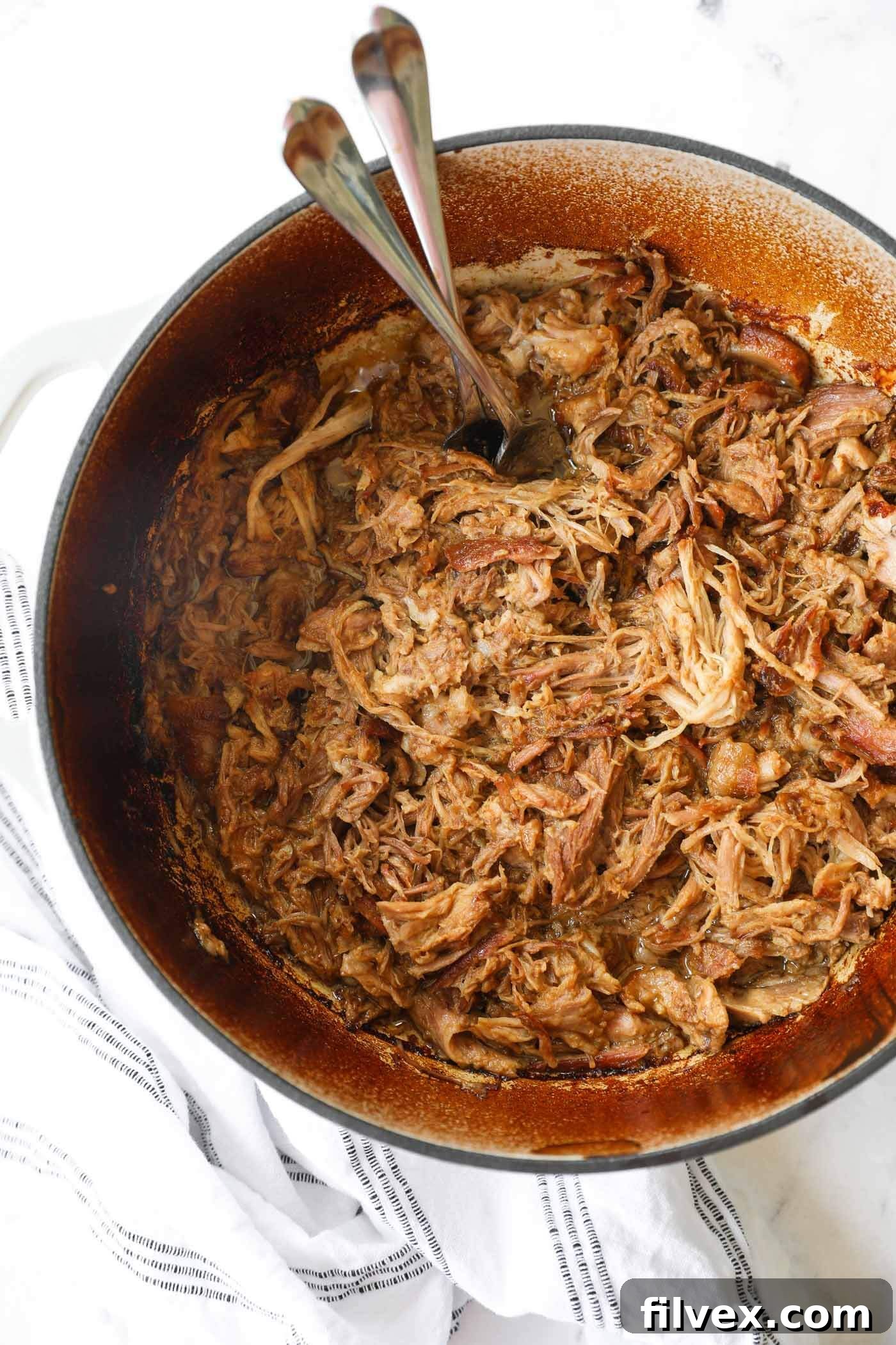 A stunning overhead shot of perfectly shredded Dutch Oven Pulled Pork, ready to be served.