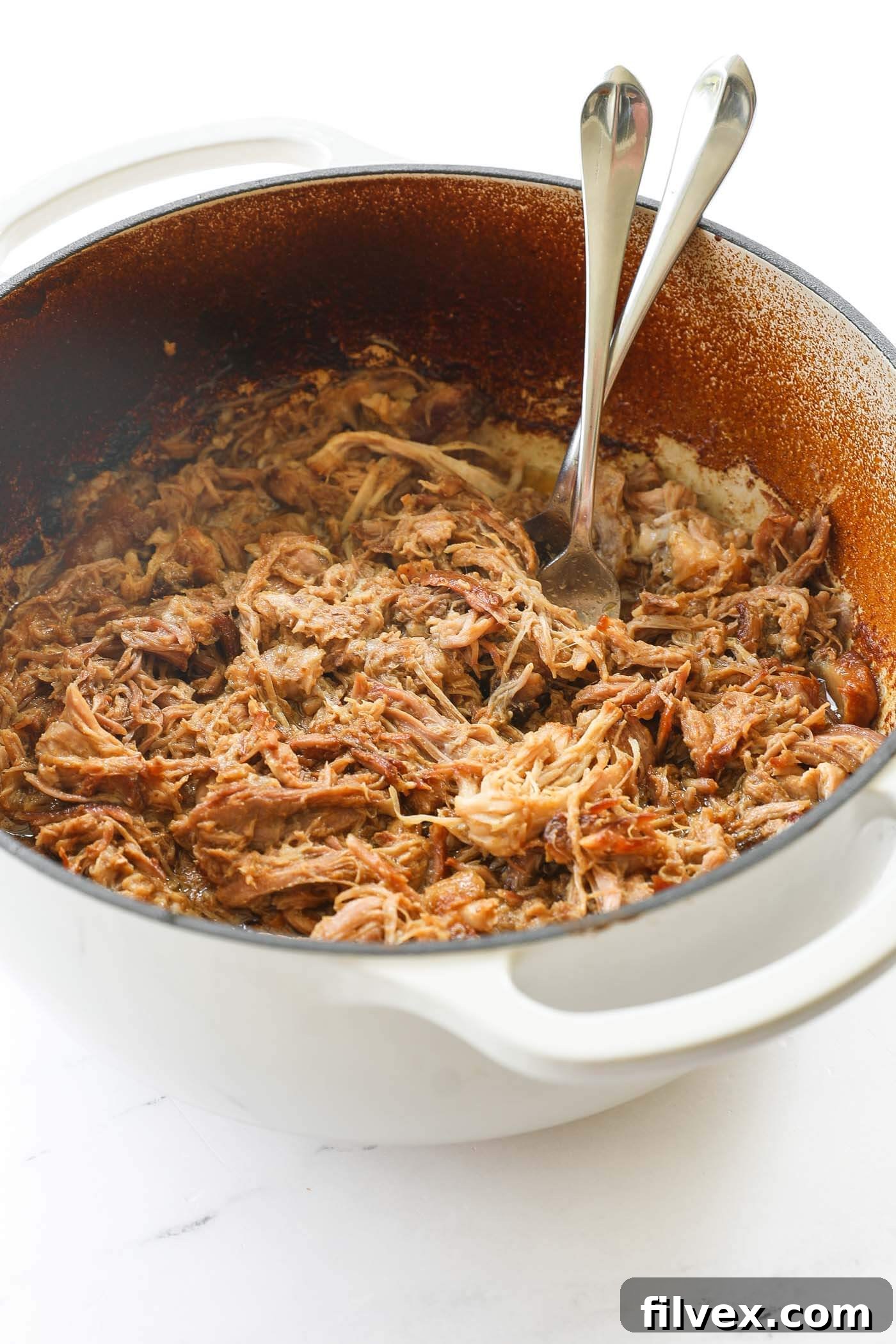 A close-up shot of the incredibly tender and juicy shredded Dutch Oven Pulled Pork.