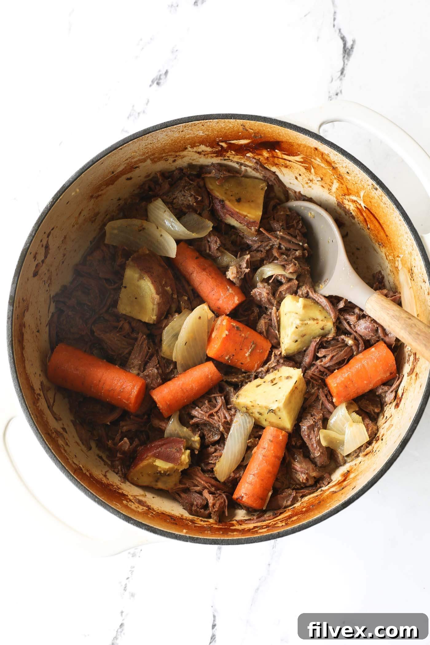 Close-up of a rustic Dutch oven pot roast with rich gravy