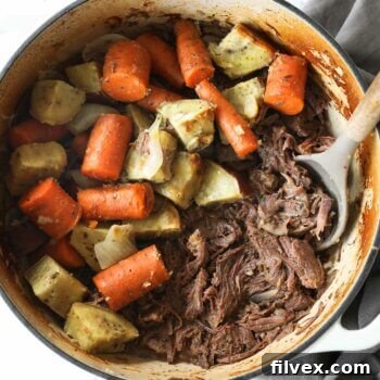 Shredded Dutch oven pot roast with carrots and potatoes