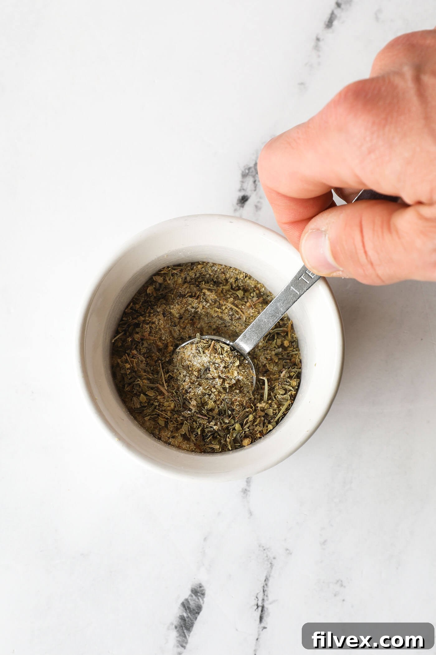 Mixing homemade pot roast seasoning in a small bowl
