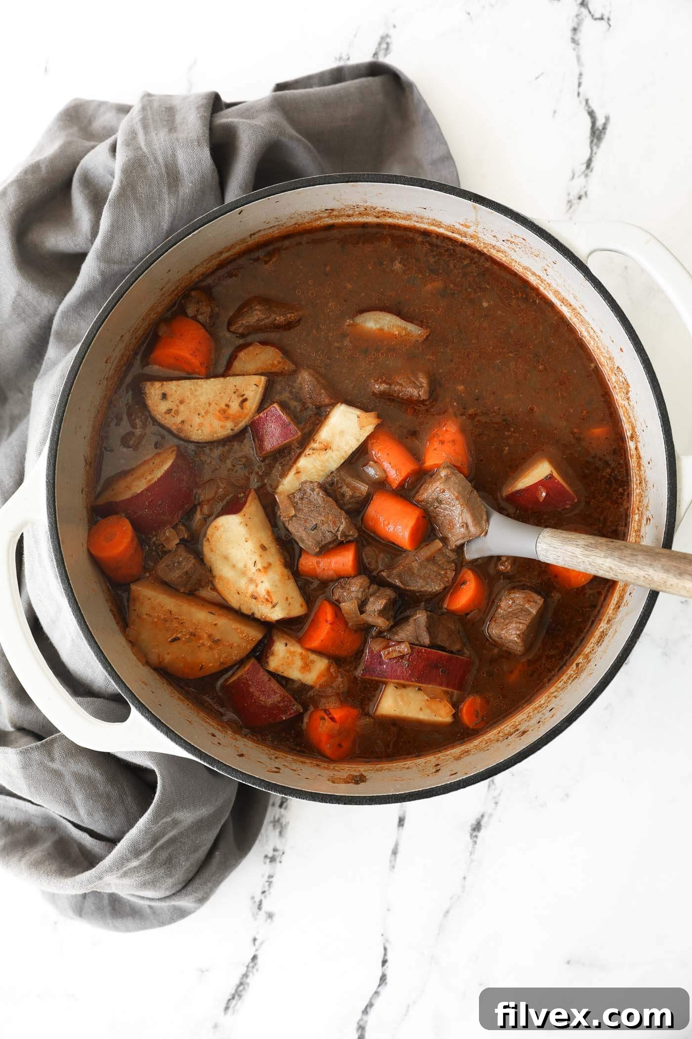 A close-up shot of the rich, thick Dutch oven beef stew with tender chunks of meat and vegetables.