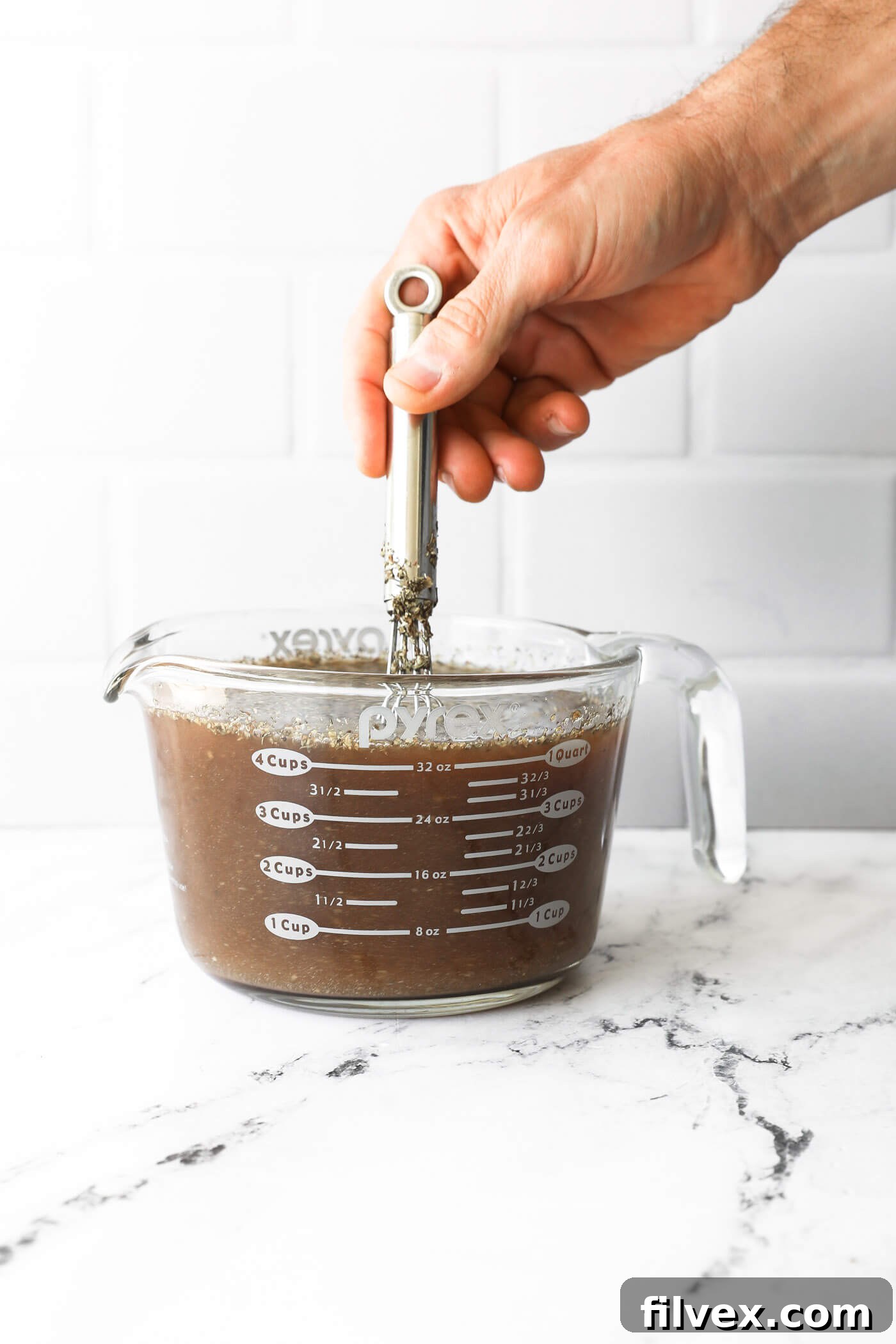 Stirring the stew broth mixture vigorously before adding it to the pot.