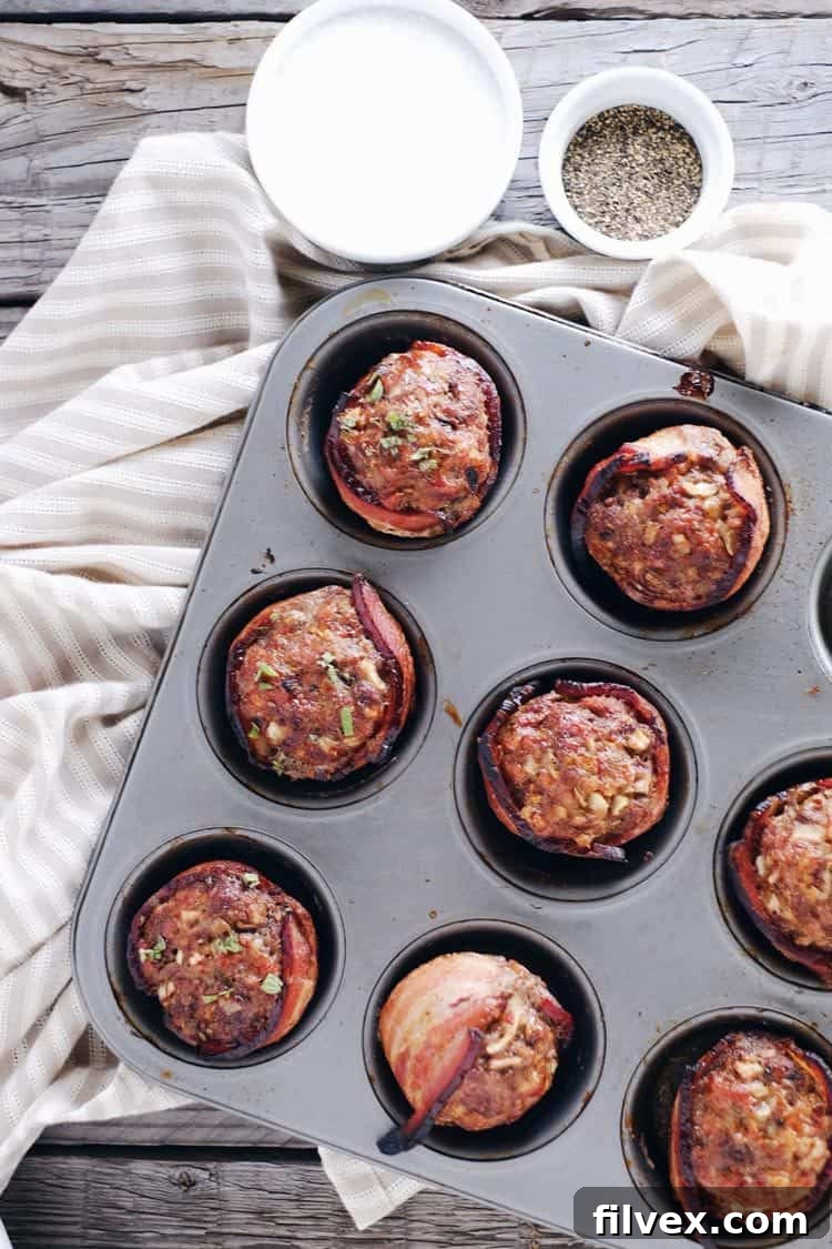 Hands preparing mini bacon wrapped meatloaves, emphasizing the quick and easy prep time for this healthy recipe.
