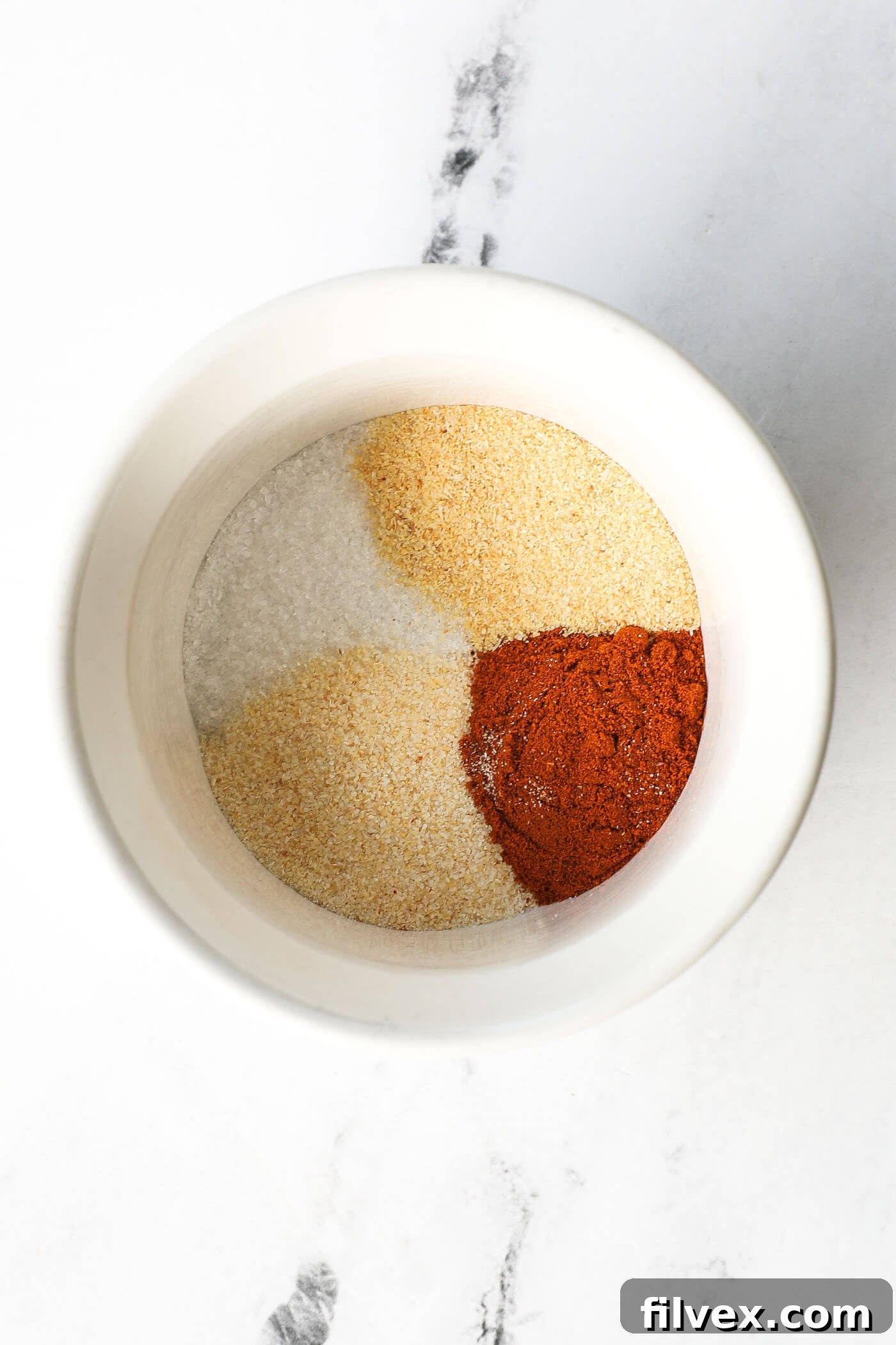 Overhead image of a ramekin with seasonings in it.