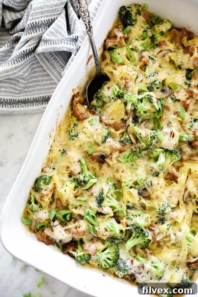 Overhead vertical image of a casserole dish filled with creamy garlic spaghetti squash, ready to be served.