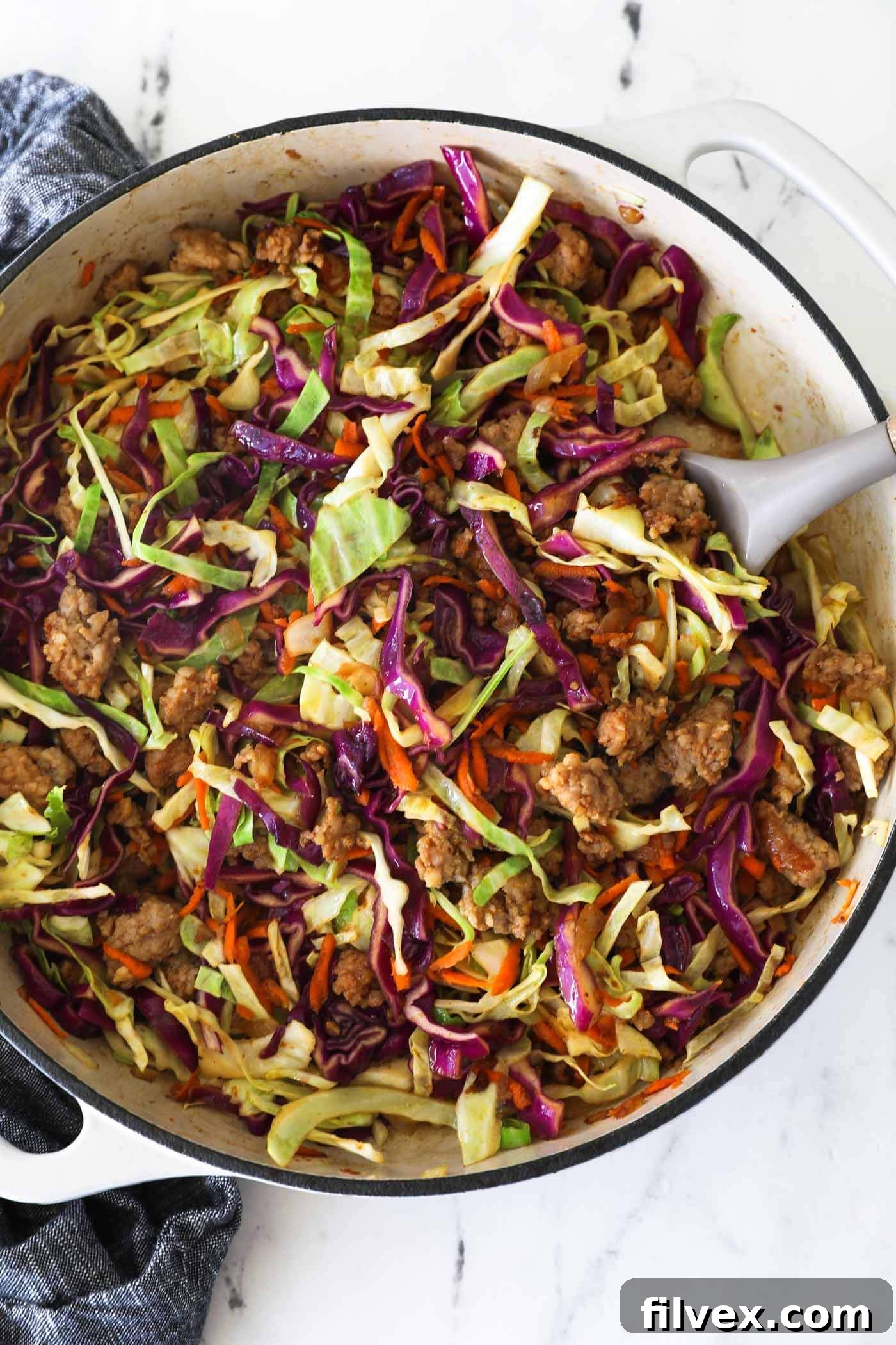 A vibrant ground pork and cabbage skillet dinner, ready to be served from a single pan.