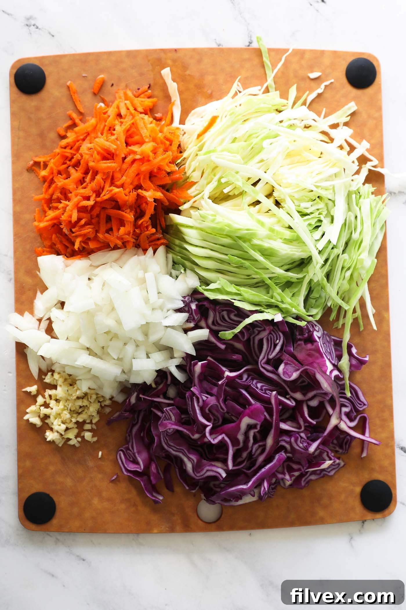 Step 2: Freshly chopped onion, garlic, cabbage, and carrots prepared for cooking.