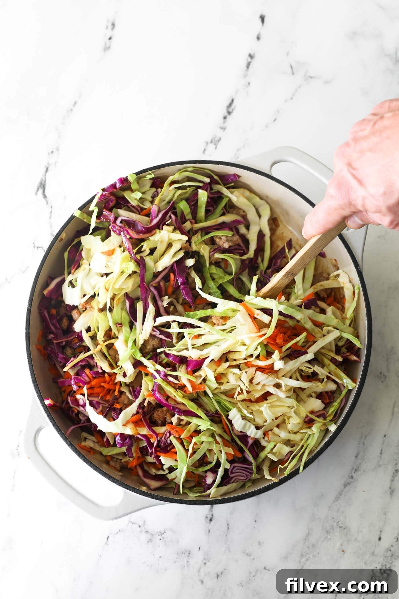 Step 6: All ingredients in the skillet being stirred together, coated in the savory sauce.