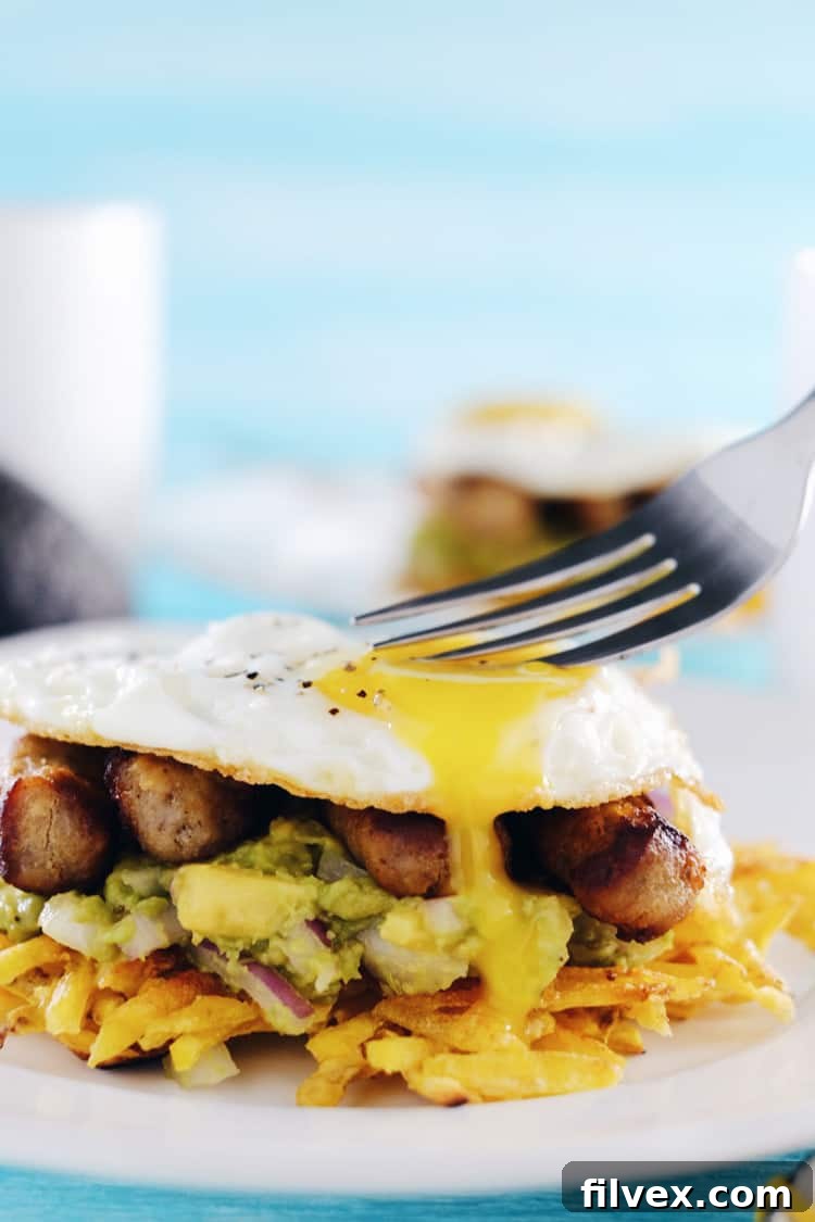 These paleo breakfast stacks are an easy to make favorite. A Whole30 breakfast with plantain hash browns, simple guacamole, sausage and eggs! Paleo, Whole30, Gluten-Free + Dairy-Free. | realsimplegood.com