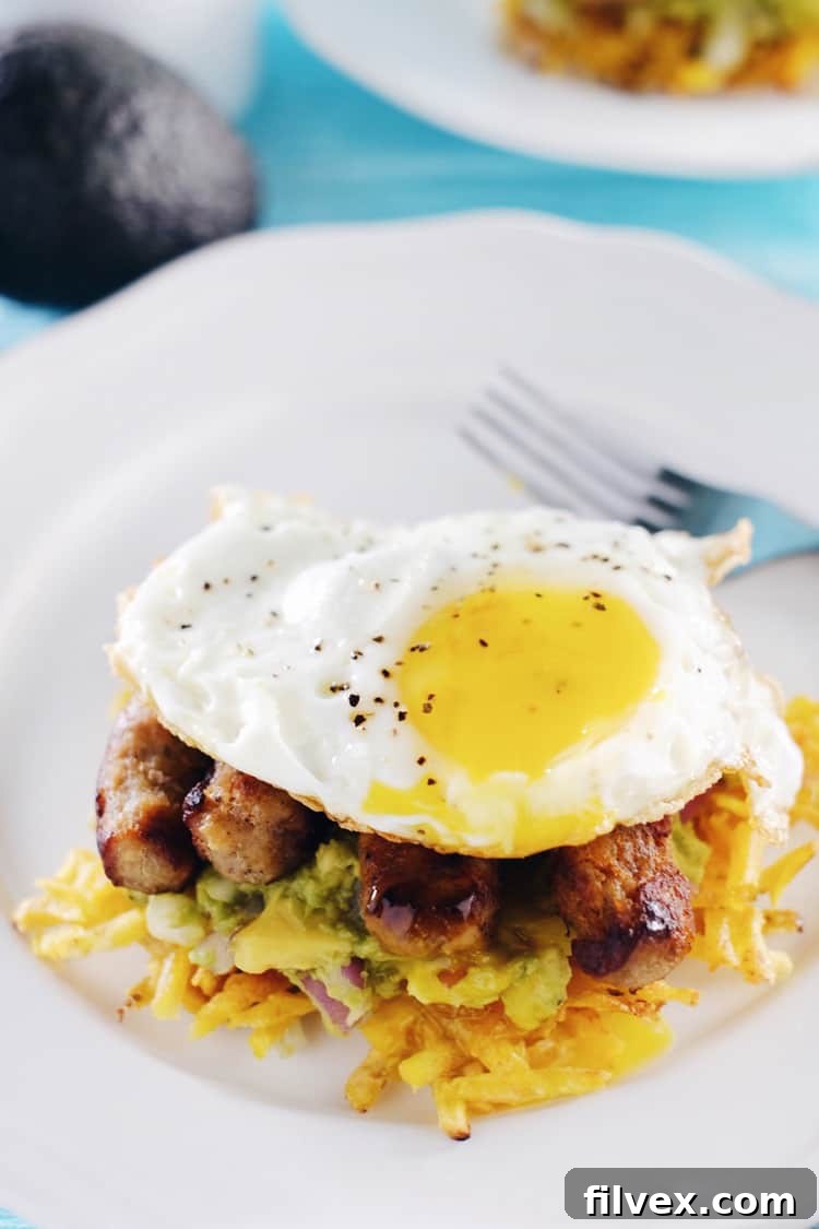 These paleo breakfast stacks are an easy to make favorite. A Whole30 breakfast with plantain hash browns, simple guacamole, sausage and eggs! Paleo, Whole30, Gluten-Free + Dairy-Free. | realsimplegood.com