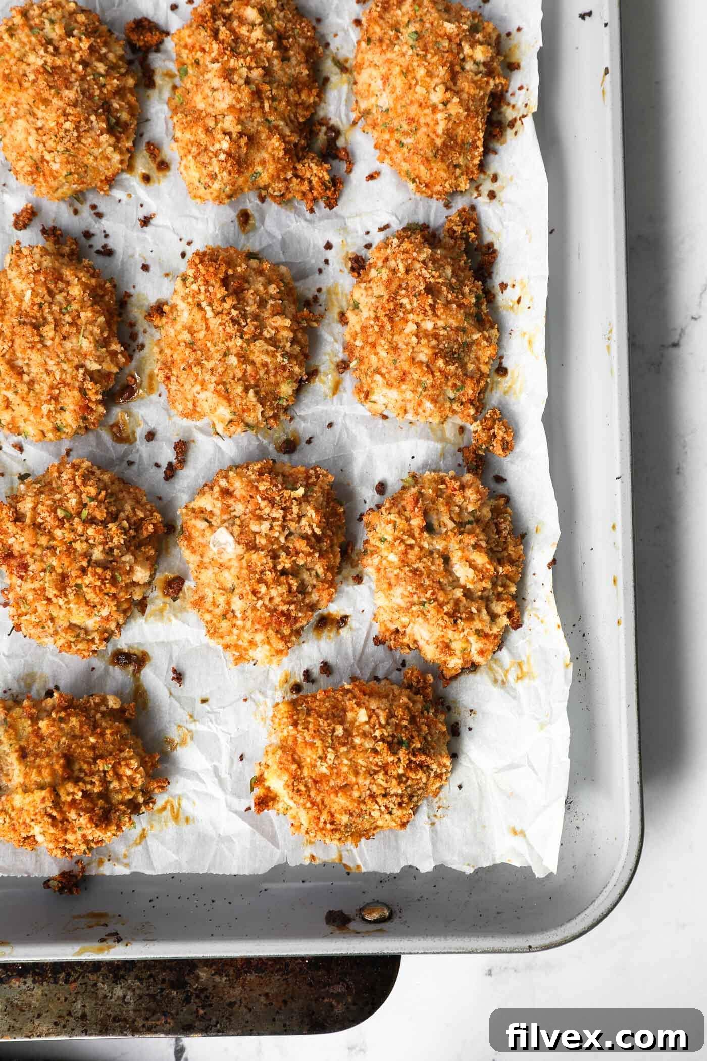 Crispy baked homemade ground chicken nuggets on a baking sheet