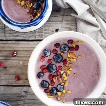 Close-up of a Berry Protein Smoothie Bowl with toppings.
