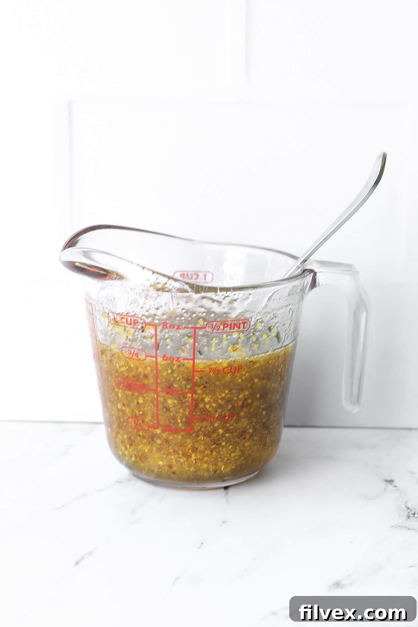 A bowl of vibrant honey mustard marinade, ready for use with chicken or pork.