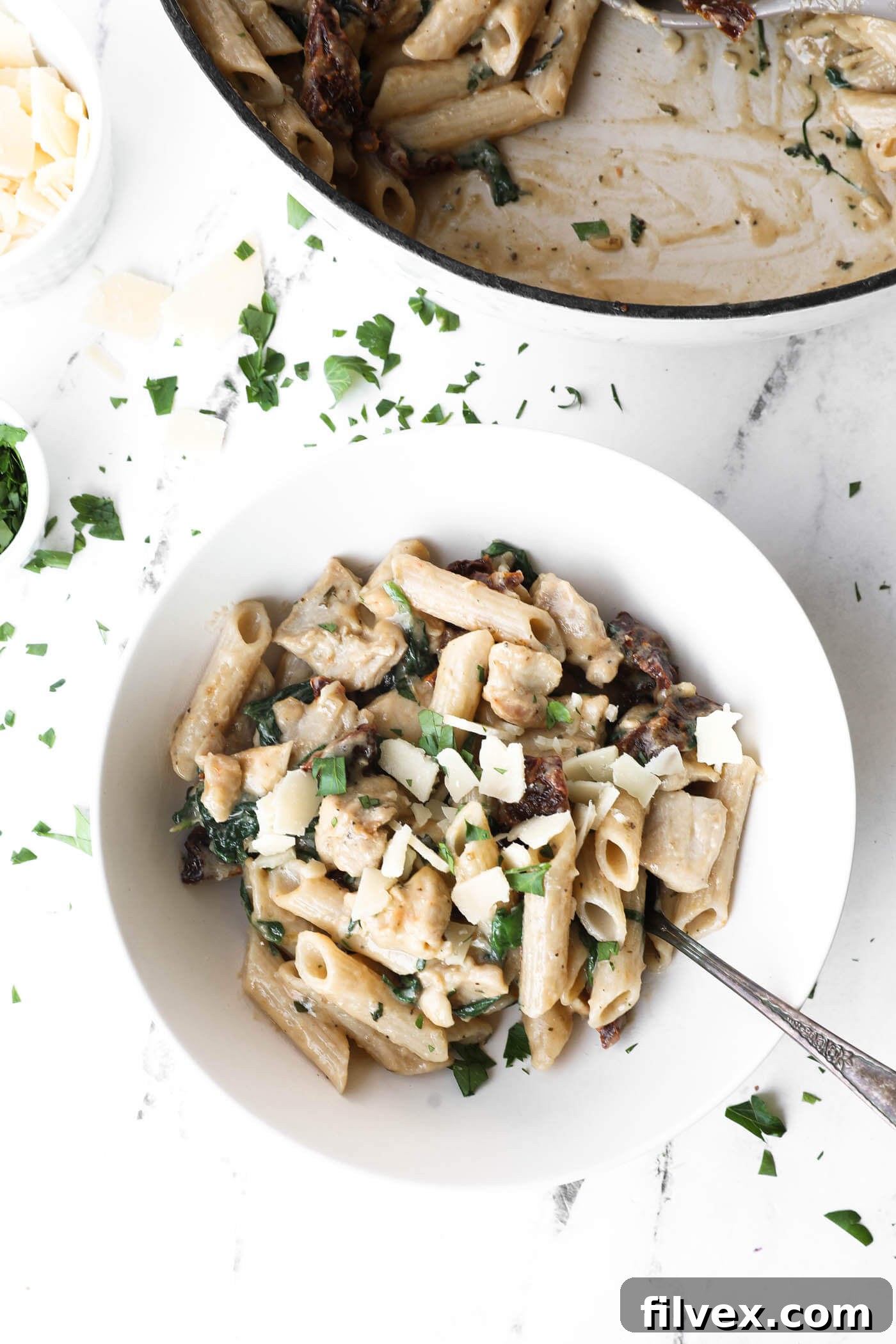 A bowl of Marry Me Chicken Pasta garnished with fresh parsley.