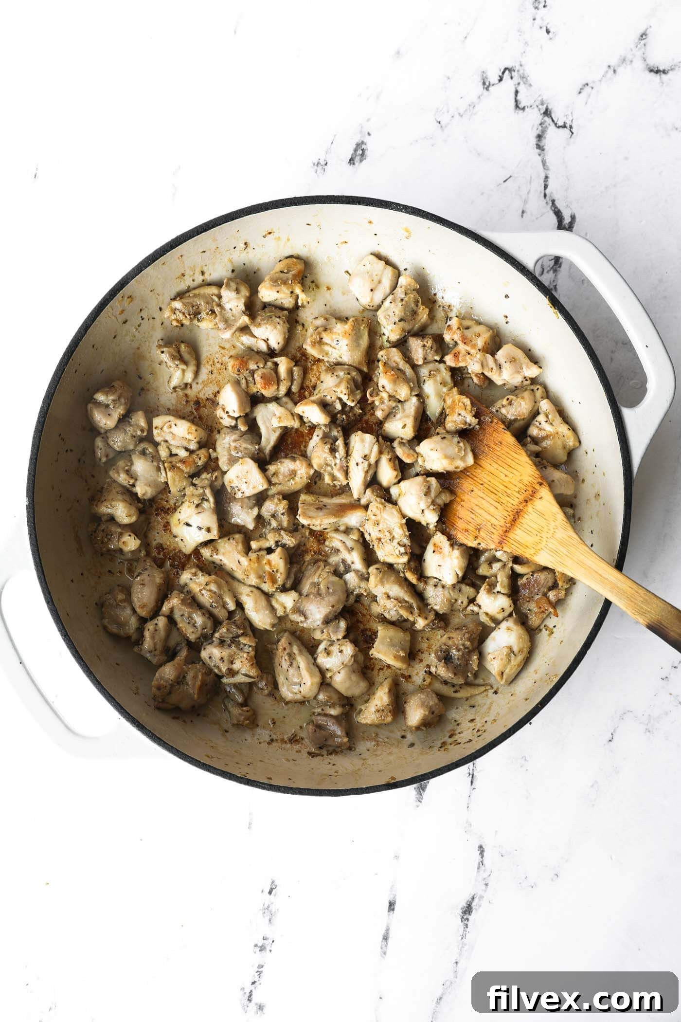Chicken browning in a skillet.