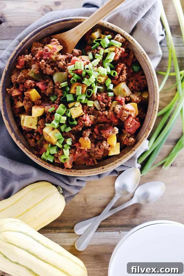 Paleo Squash Chili with vibrant fall colors and ingredients like butternut squash, bell peppers, onions, and ground beef. Perfect for Whole30 and gluten-free diets.
