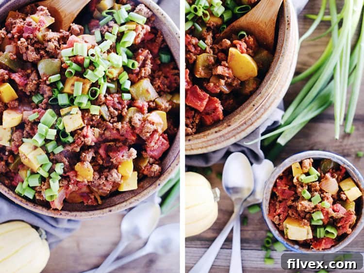 Overhead view of a vibrant bowl of Paleo Squash Chili, garnished with fresh green onions, ready to be enjoyed.