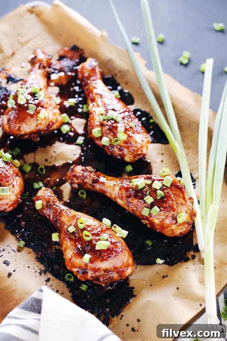 Perfectly baked balsamic glazed chicken drumsticks with crispy skin, glistening with a rich, sticky sauce, ready to be devoured. Paleo and Gluten-Free.