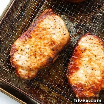 Close up overhead shot of air fryer cooked pork chops from frozen, perfectly golden