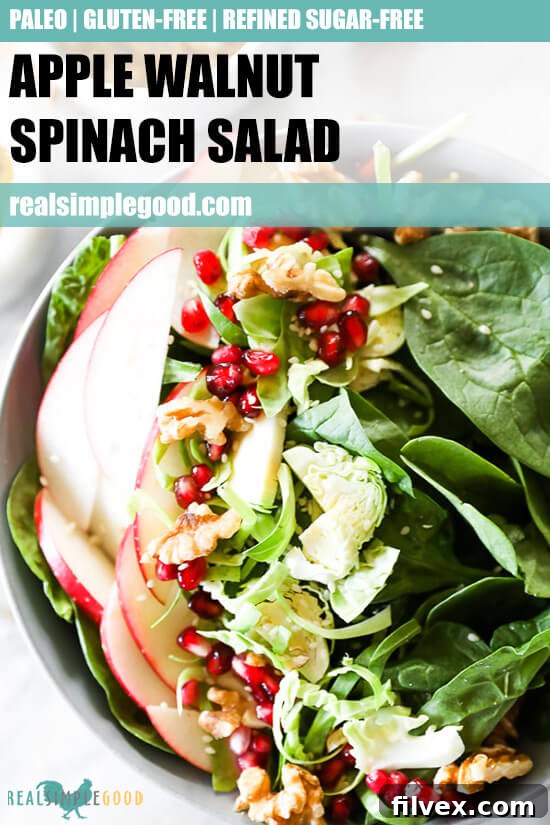Close-up vertical image of apple walnut spinach salad in a bowl with an encouraging text overlay: 'Healthy & Delicious!'