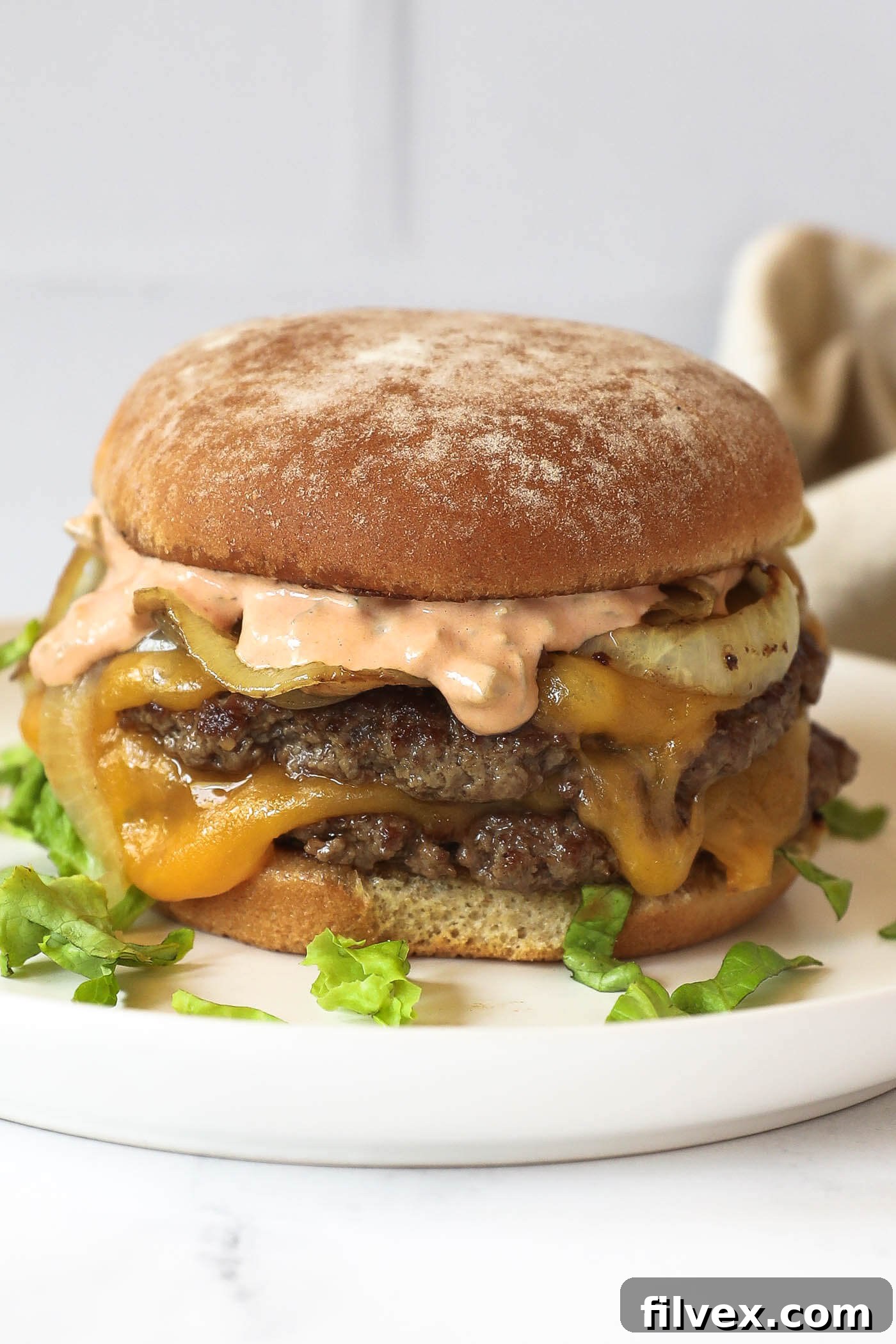 Perfectly seared smash burgers cooking on a griddle