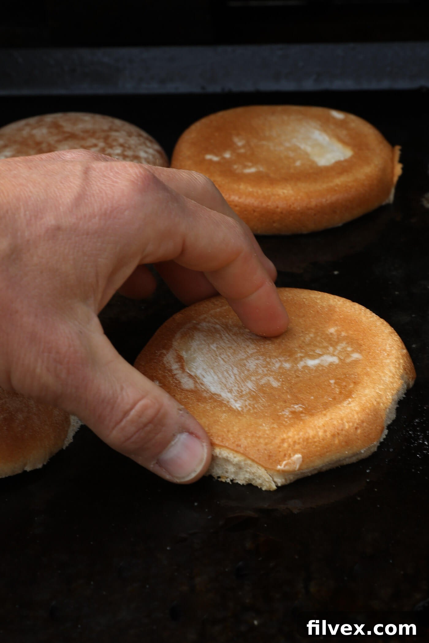 Toasting buttered burger buns on a griddle