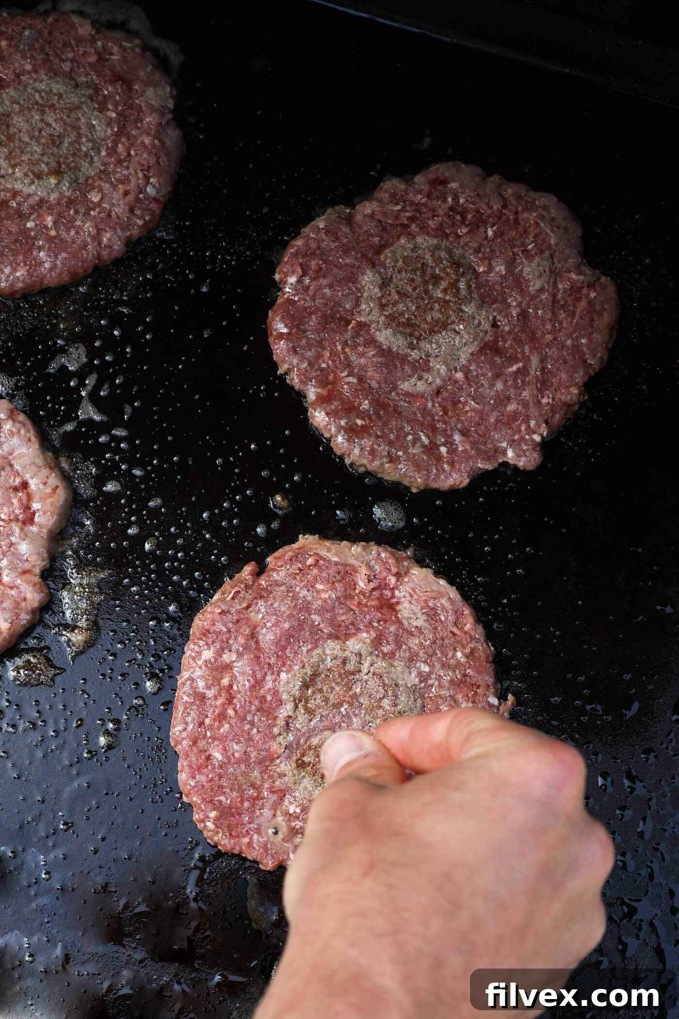 Seasoning smash burger patties with salt