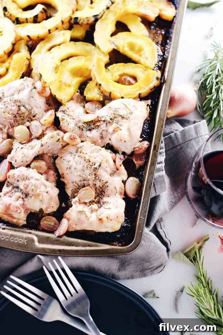 Delicious one-pan Paleo and Whole30 Sheet Pan Chicken and Squash Dinner with grapes, perfect for fall and winter meals. Gluten-Free and Dairy-Free recipe.
