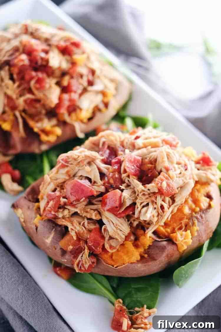 Fire up your crockpot for a delicious Maple Chipotle Chicken dish. This easy slow cooker recipe creates tender, flavorful chicken perfect for stuffing sweet potatoes, ideal for a hearty cold-weather dinner. Paleo and Gluten-Free.
