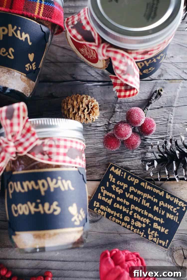 Close-up of a DIY Paleo pumpkin cookie mix jar, showcasing the elegant black and gold instruction label and decorative corner stickers. This wholesome, gluten-free mix makes a perfect clean holiday gift.