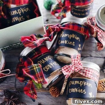 A vibrant image of a DIY Paleo Pumpkin Cookies in a Jar, perfectly assembled as a wholesome holiday gift, showcasing its clean ingredients and festive presentation. This gluten-free and dairy-free treat is ready to be baked and enjoyed.