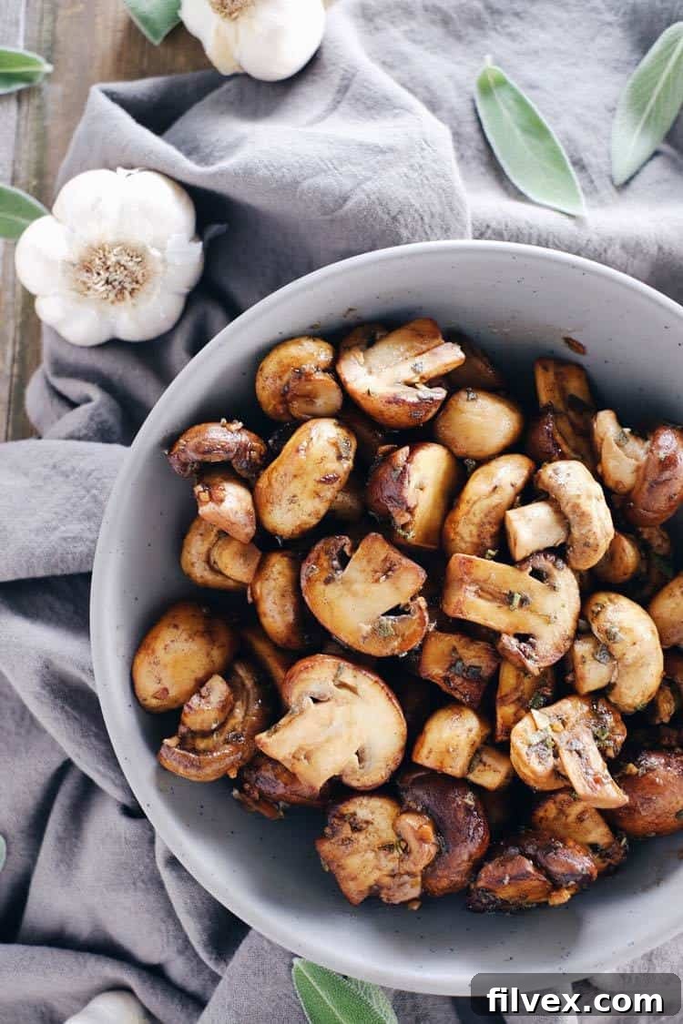 Several cloves of fresh garlic, finely minced and ready to be incorporated into the savory mushroom dish.