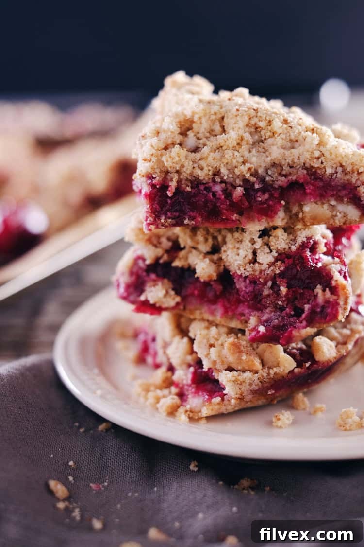 The vibrant color of these cranberry orange crumble bars feels so festive, making them a holiday favorite! Allergy-free and so buttery and delicious! Paleo, Gluten-Free, Dairy-Free + Refined Sugar-Free. | realsimplegood.com