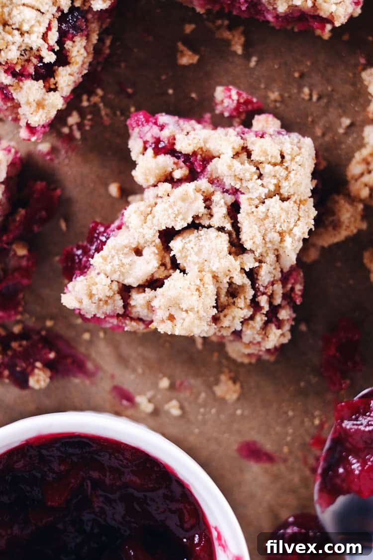 The vibrant color of these cranberry orange crumble bars feels so festive, making them a holiday favorite! Allergy-free and so buttery and delicious! Paleo, Gluten-Free, Dairy-Free + Refined Sugar-Free. | realsimplegood.com