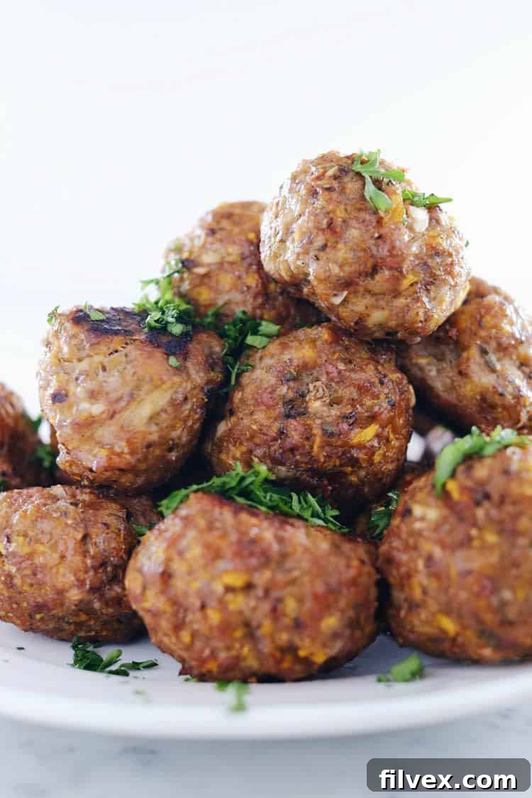 Butternut breakfast meatballs served with a side of fresh greens, demonstrating a healthy and delicious way to enjoy an egg-free, Paleo, and Whole30 breakfast.