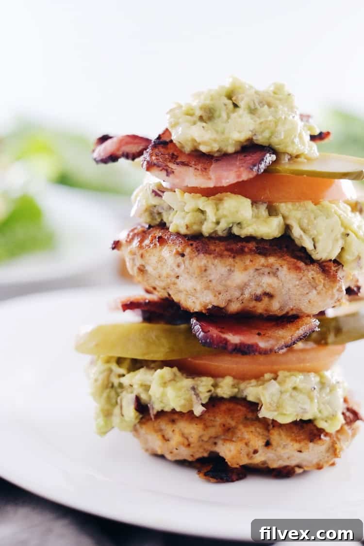Delicious and healthy Chipotle Turkey Burgers served with crispy bacon and fresh guacamole in a lettuce wrap, perfect for Paleo, Whole30, Gluten-Free + Dairy-Free diets.
