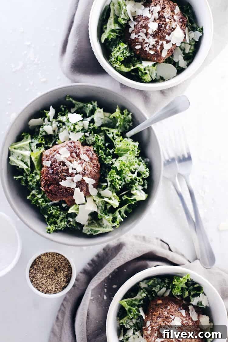 A vibrant kale caesar burger bowl with a creamy Paleo and Whole30 dressing, topped with optional dairy-free parmesan. Perfect for a quick, satisfying, and healthy meal any time of day. Paleo, Whole30, Gluten-Free, and Dairy-Optional.