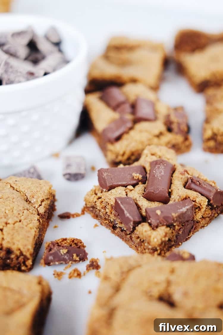 Delicious gluten-free and dairy-free chocolate chip cookie bars, perfect for a quick and easy paleo-friendly dessert. Enjoy melted chocolatey goodness with minimal effort. | realsimplegood.com