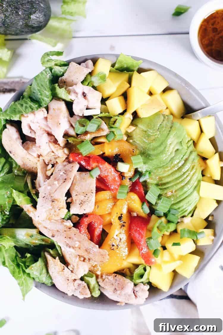 Freshly chopped romaine lettuce, diced mango, and green onions for a chili lime chicken salad base.